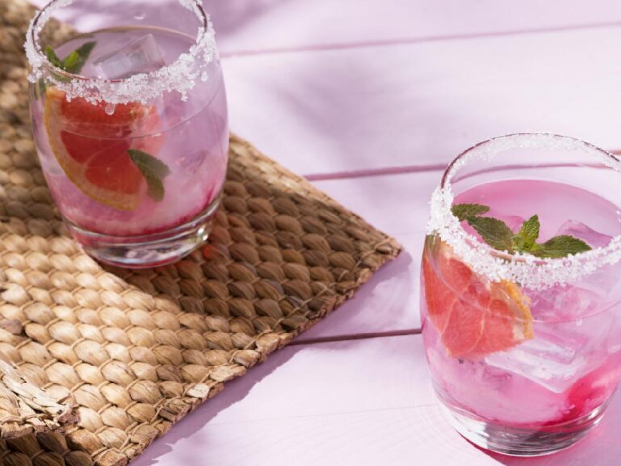 two sugar-rimmed glasses of a pink drink