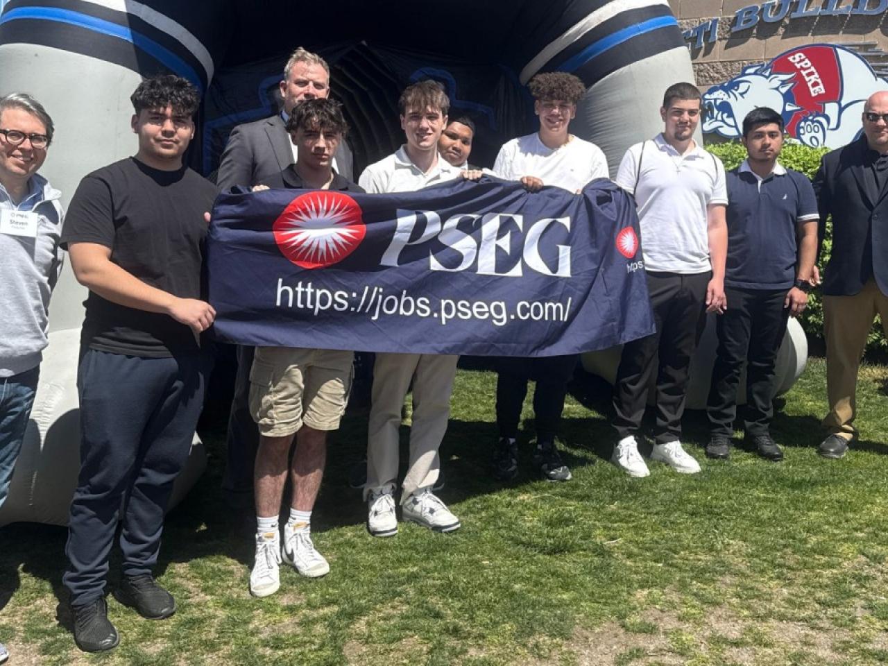 people holding a PSEG banner