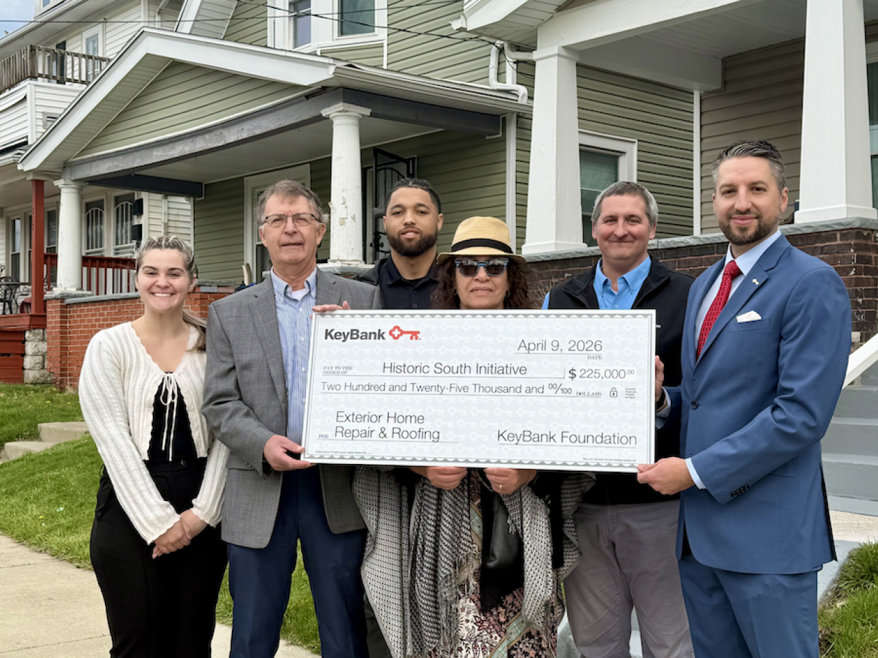 group of people holding up check
