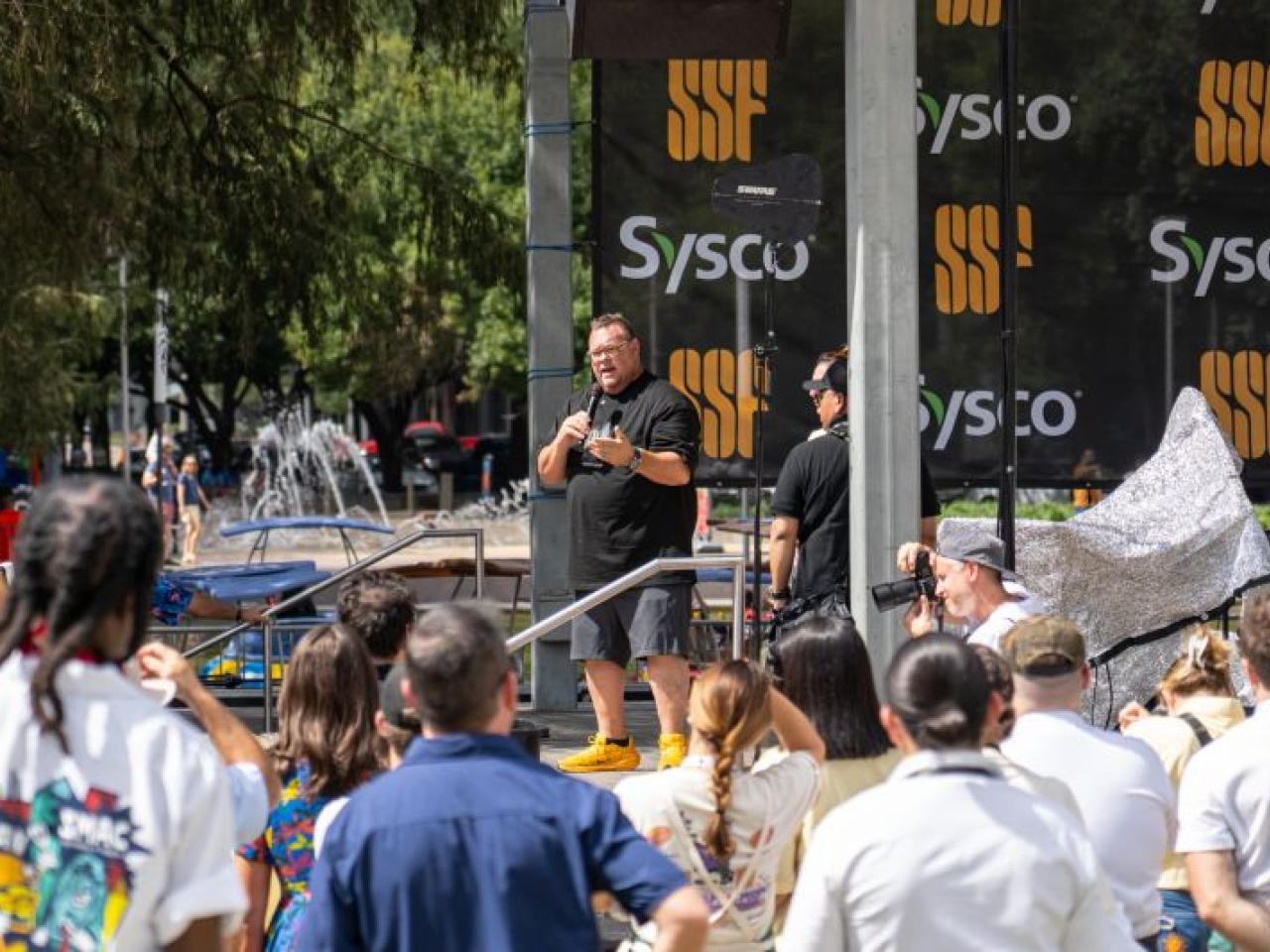 person speaking at outdoor event