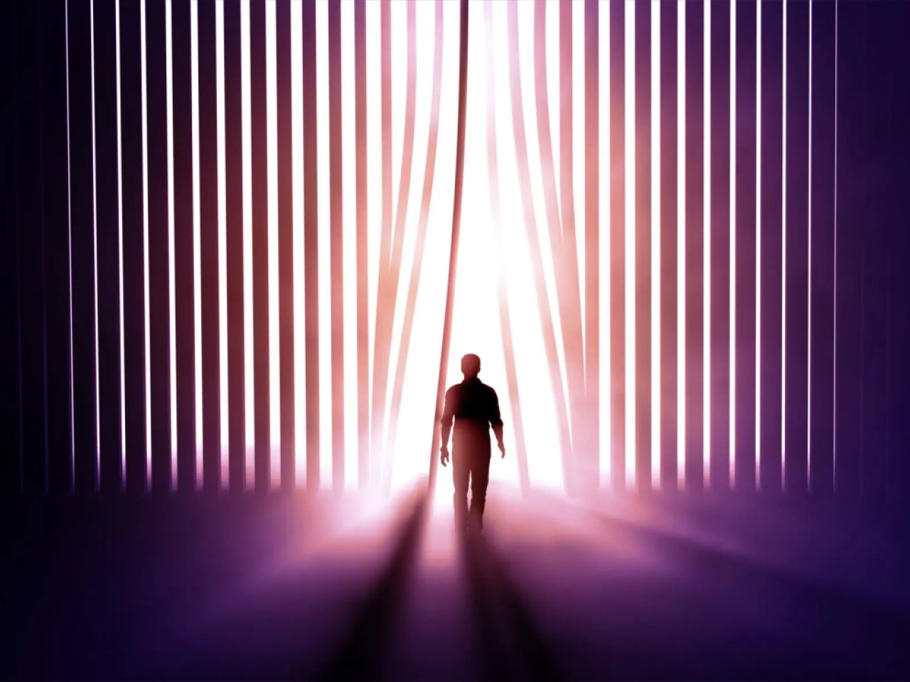 A silhouette of a person walking through vertical panels into light