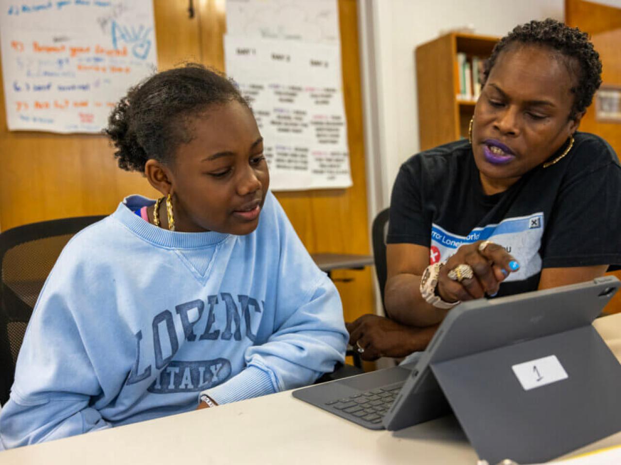 A teacher working with a student