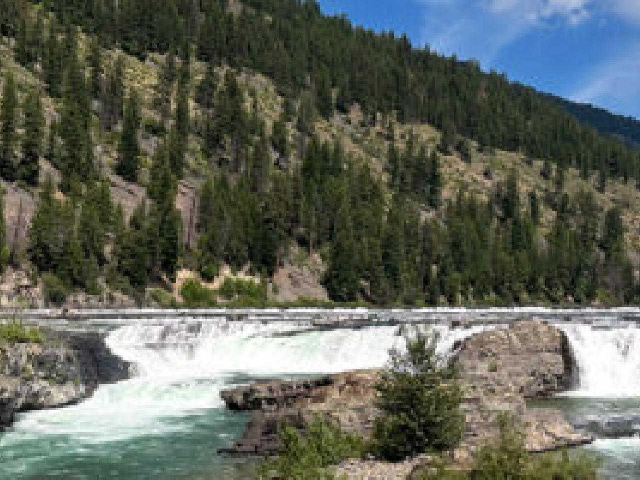 A river running next to a mountain