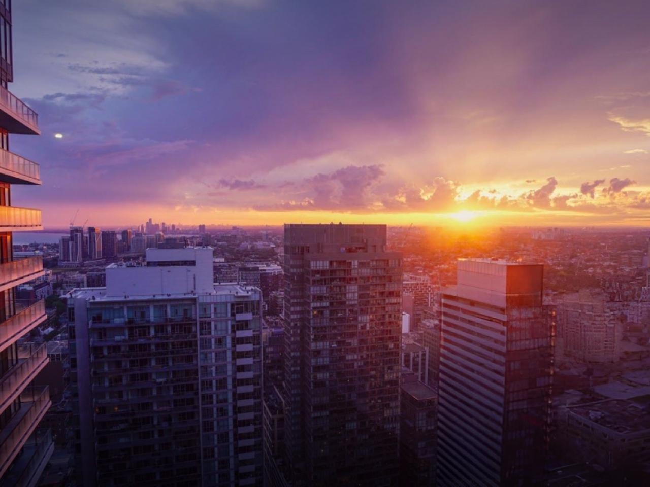 Sunsetting in the distance. A city landscape in front.