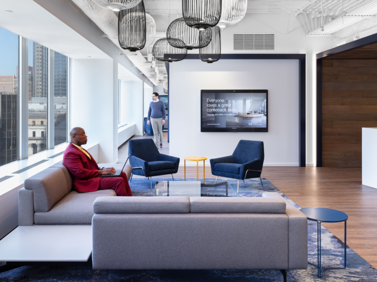 People inside office space with chairs and couches