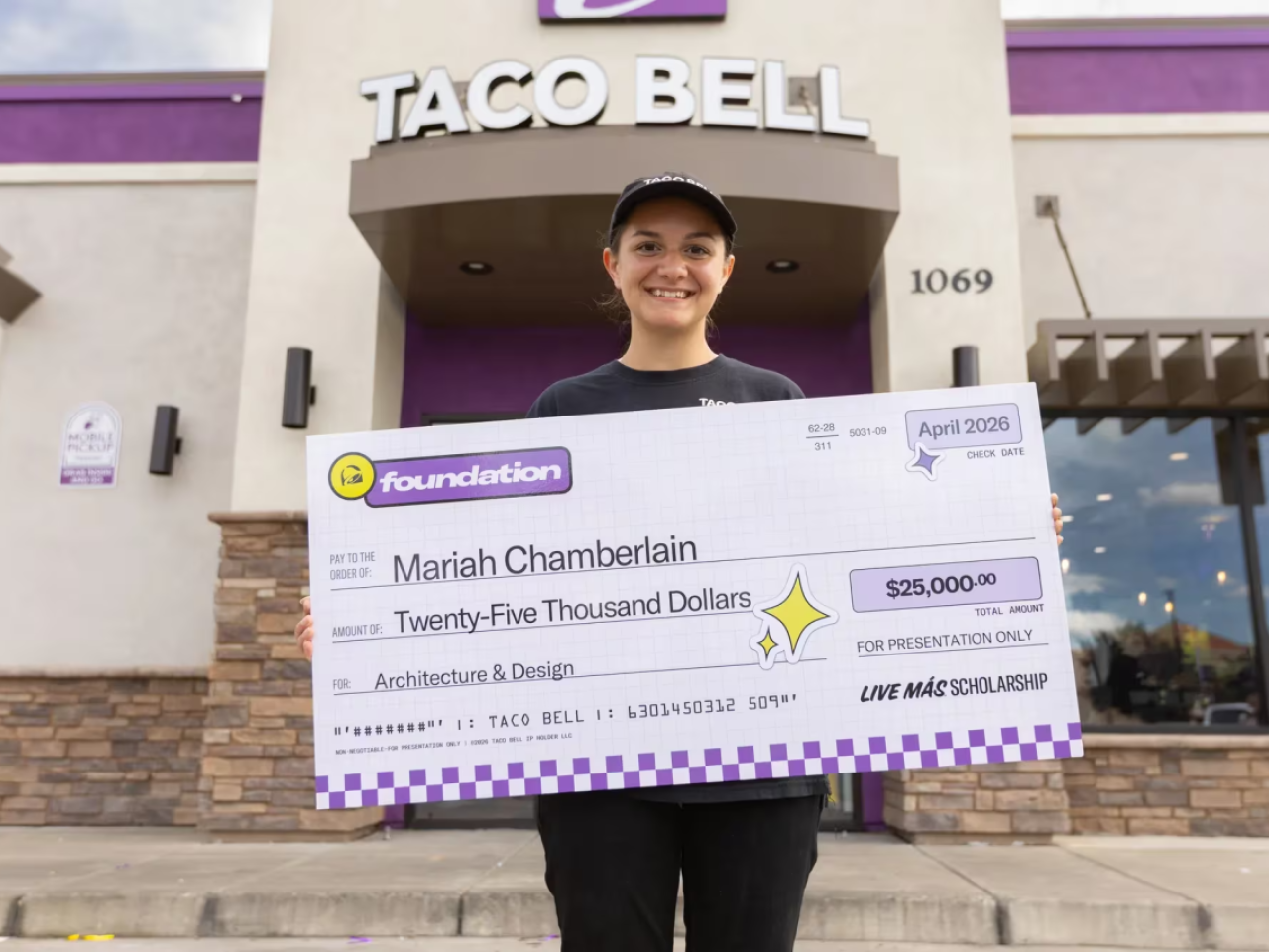 Mariah Chamberlain holding an oversized check
