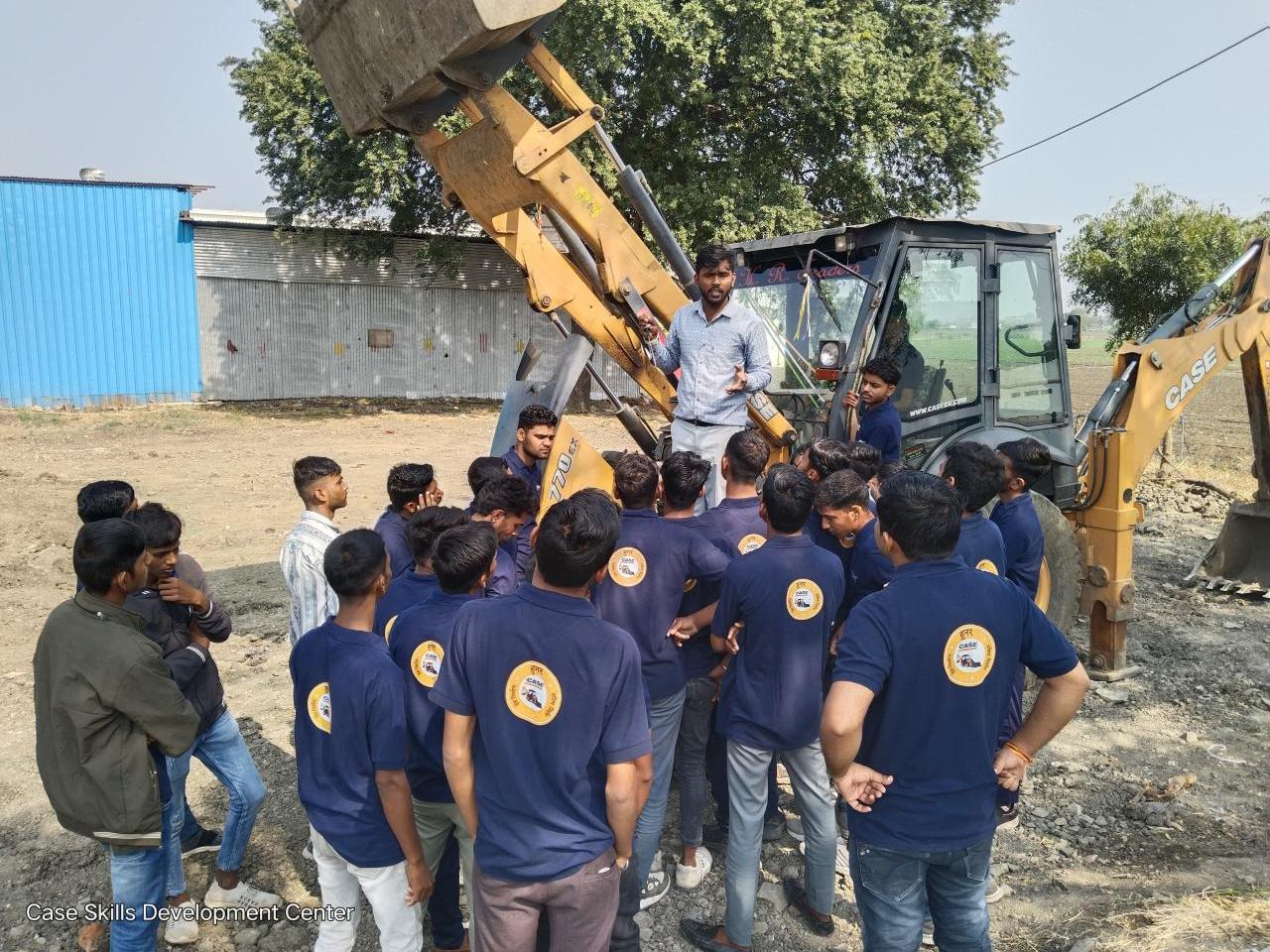A group of students around farm machinery