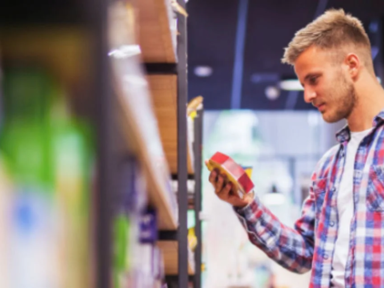 A customer looking at a product from a shelf