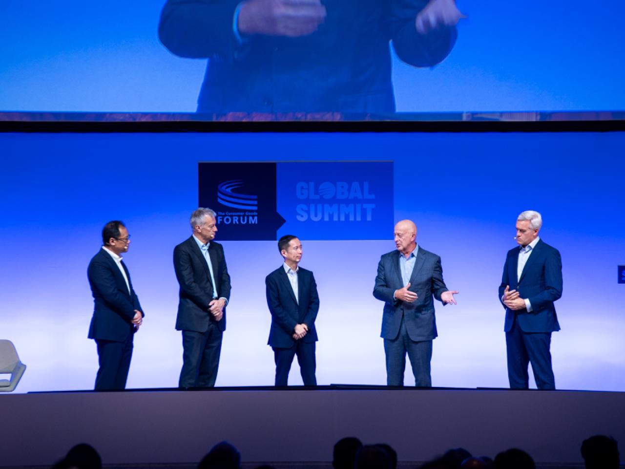 Five leaders in line on a stage