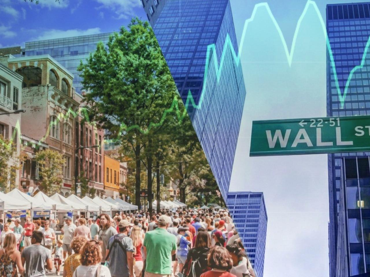 people walking down Wall St.