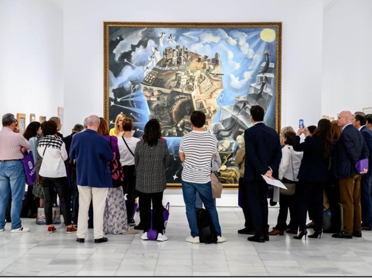 A small crowd admiring a large painting