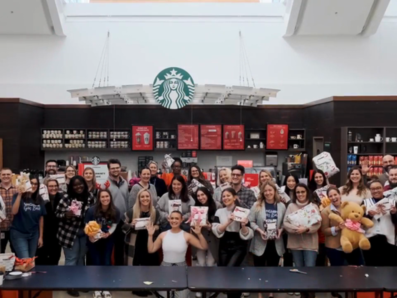 group of people standing in front of a Starbucks