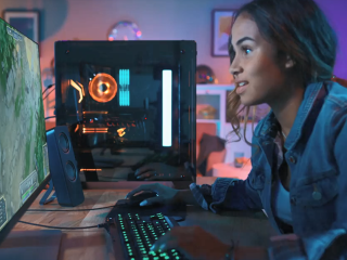A person playing a game on a desktop computer, using the keyboard as a controller. 