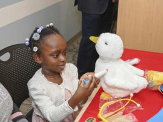 Child shown playing with her My Special Aflac Duck.
