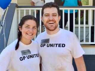 Anthony Reyna and his wife, Corinne, in front of a house