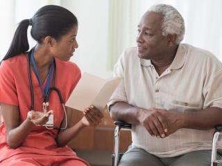 Female black doctor consulting with a male, black patient.