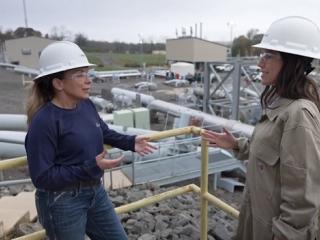 2 people in hardhats talking
