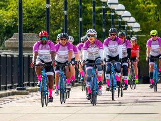 Riders crossing a bridge in a peloton.