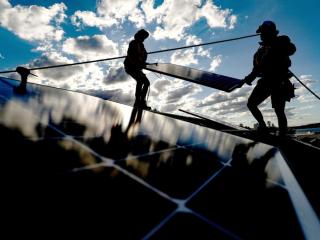 People installing solar panels