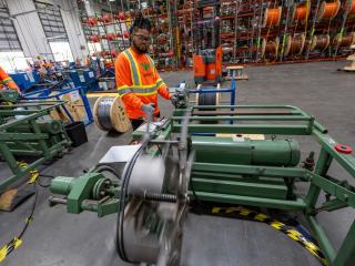 Wesco employee cutting spool wire.