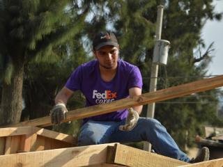 FedEx volunteer lifting building materials