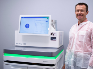 Daniel with the Illumina NovaSeq 6000, nicknamed "PoppySeq" at the PetDx offices.