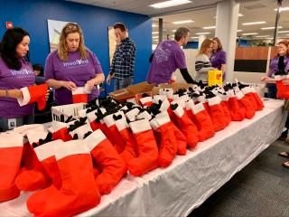 volunteers pack stockings full 
