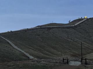 Panoramic view of the valley, a winding road up to a large, brightly lit star.