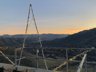 A panoramic view of a valley at sunset. 