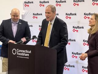 KeyBank's Matthew Hummel speaking to the group from a podium.