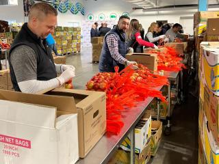 Assembly line of volunteers at Conn. Food Share warehouse.