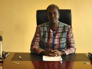 Lydia Nsekera sitting at a desk