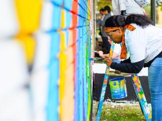 person painting a mural