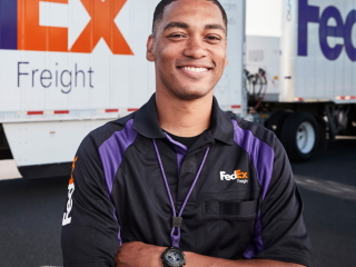 Fedex Employee smiling with arms crossed