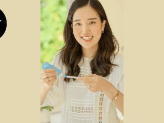 Vicki Jung in a home setting, putting toothpaste on a brush.