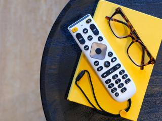 new large button remote with glasses on a side table