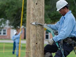 Lineworker on telephone pole