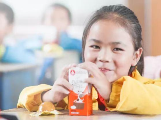 Girl drinking milk and smiling