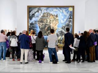 A small crowd admiring a large painting