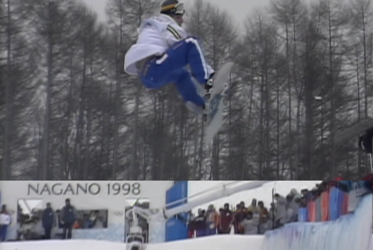 Snowboarder in the air on a half-pipe run.