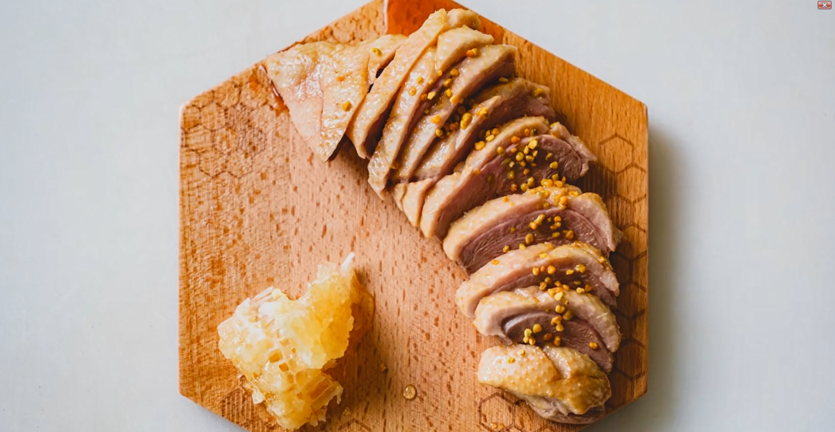 A plated dish of sliced duck and honeycomb