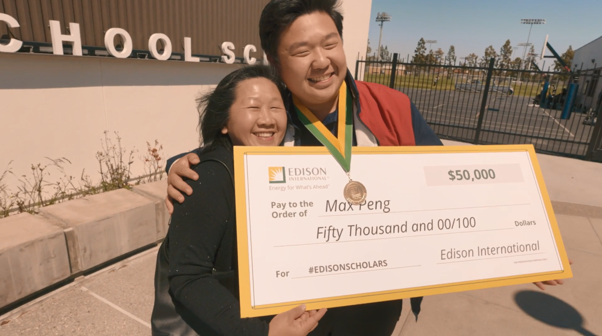 Max Peng with his Mom and a large check.