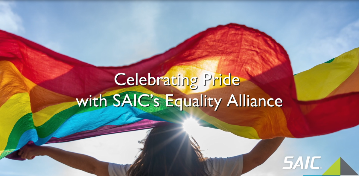 Celebrating Pride with SAIC's Equality Alliance. A person with rainbow flag.
