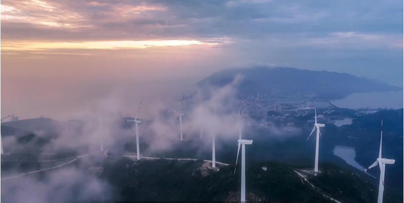 wind turbines in a cloudy sky.