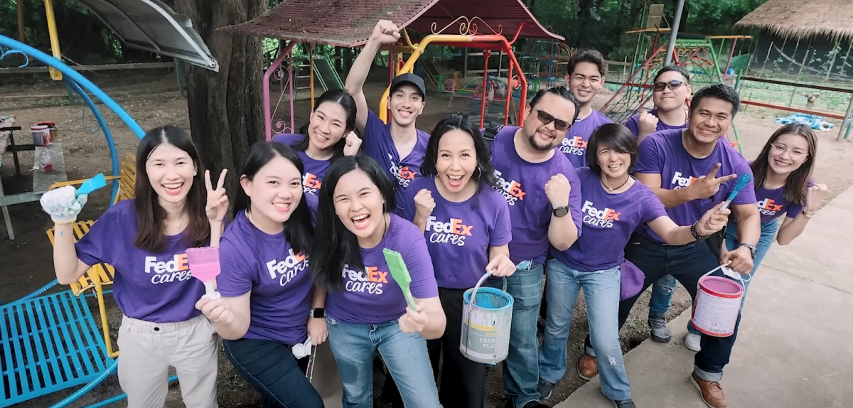 A team of volunteers, smiling to the camera.