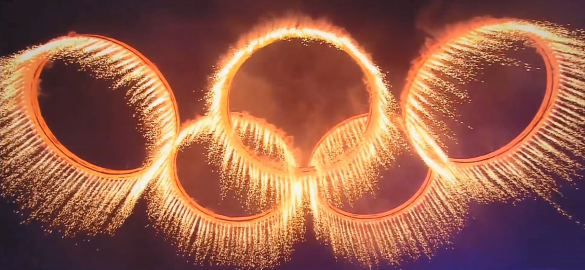 Golden sparks in the shape of the olympic rings.