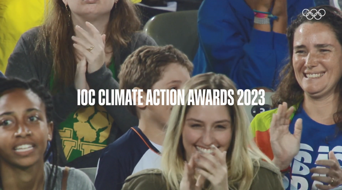 IOC Climate Action Awards 2023 over people in stadium seating clapping.