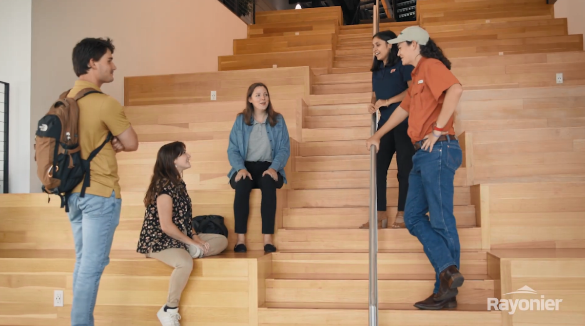 Interns in an auditorium talking casually.