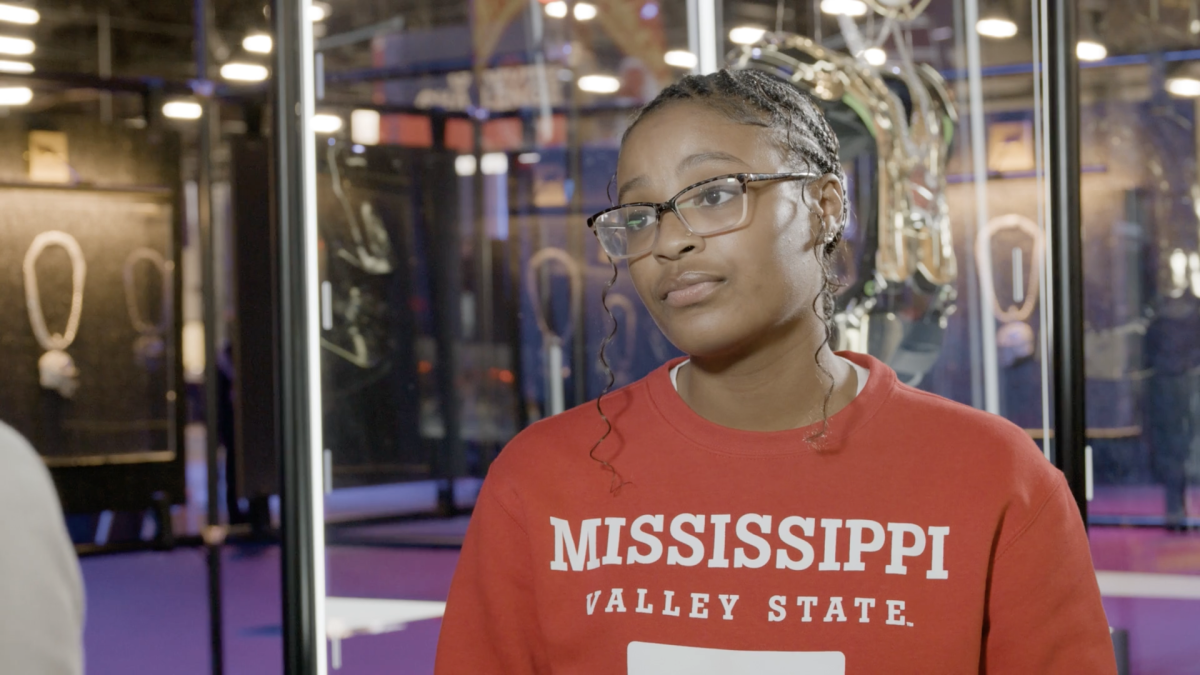 A person wearing a red university sweater 