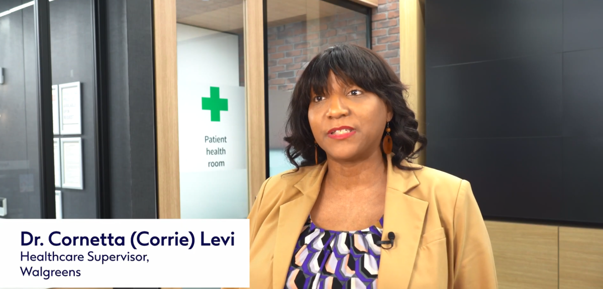 Dr. Cornetta in front of a door marked "Patient Health Room".